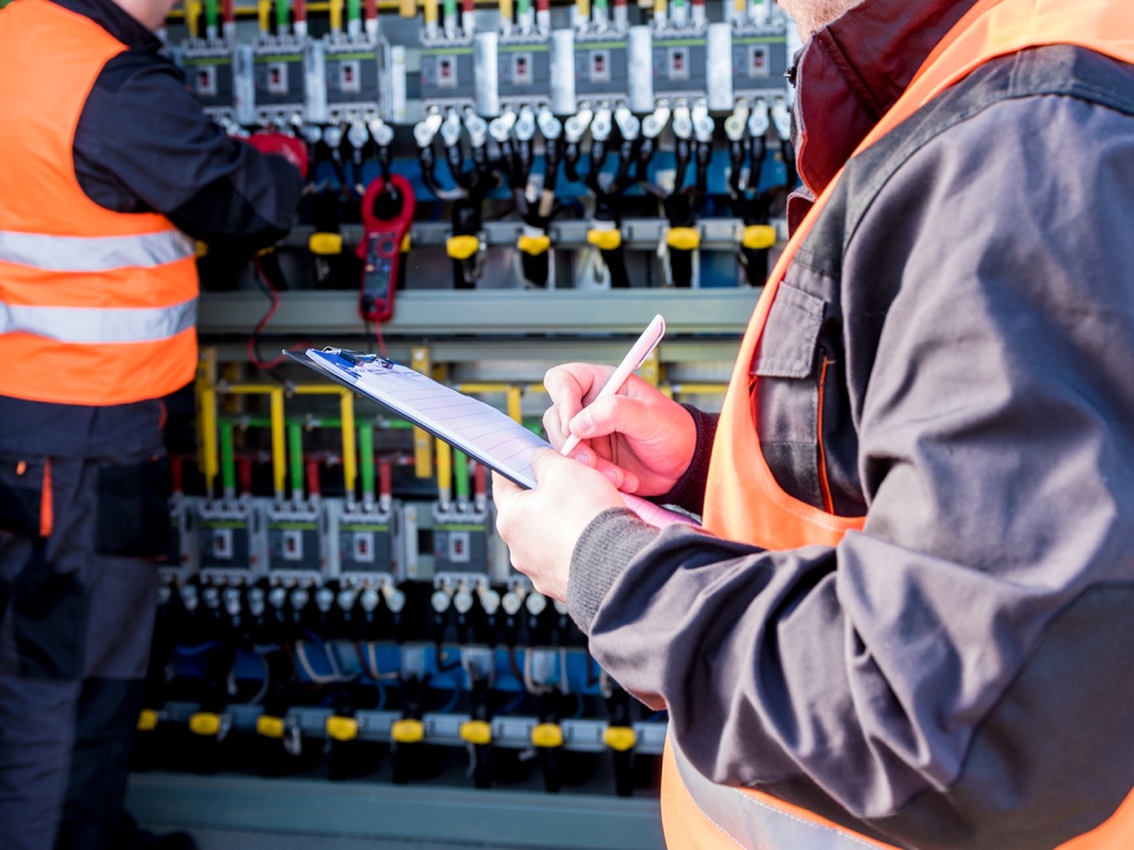 Workers checking a switchgear compartment