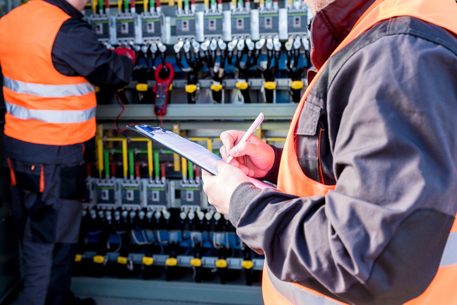 Workers checking a switchgear compartment